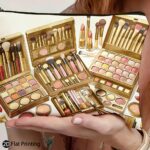 A Single Portable Bag Featuring a Golden Palette, Brushes, Lipstick, Eyeshadow, Foundation, Blush, And Setting Powder Design. It'S Lightweight, Foldable, Zippered, And Makes a Perfect Gift for Makeup Lovers with Its 2D Flat Print